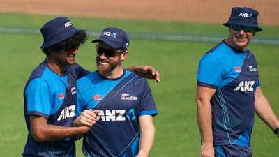 New Zealand's captain Kane Williamson, center, chats with New Zealand's Rachin Ravindra, left, as coach Gary Stead looks on during a training session (AP)