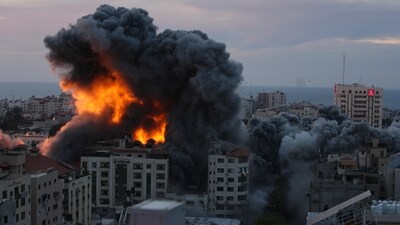 Fire and smoke rise from an explosion on a Palestine apartment tower following an Israeli air strike in Gaza City, (AP) Fire and smoke rise from an explosion on a Palestine apartment tower following an Israeli air strike in Gaza City, (AP)