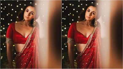 Alia accessorised her look with a pair of statement chandbalis earrings embellished with white and green emeralds. With a matching red potli bag and high heels, she perfectly styled her glamorous look. (Instagram/@stylebyami) Alia accessorised her look with a pair of statement chandbalis earrings embellished with white and green emeralds. With a matching red potli bag and high heels, she perfectly styled her glamorous look. (Instagram/@stylebyami)