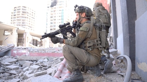 Israeli soldiers operate amid what the Israeli army says is the ongoing ground operation against the Palestinian Islamist group Hamas, in a location given as Gaza, in this screen grab from a handout video released on November 14, 2023. (Reuters)