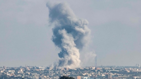 A smoke plume erupts during Israeli bombardment in Rafah in the southern Gaza Strip. A smoke plume erupts during Israeli bombardment in Rafah in the southern Gaza Strip.
