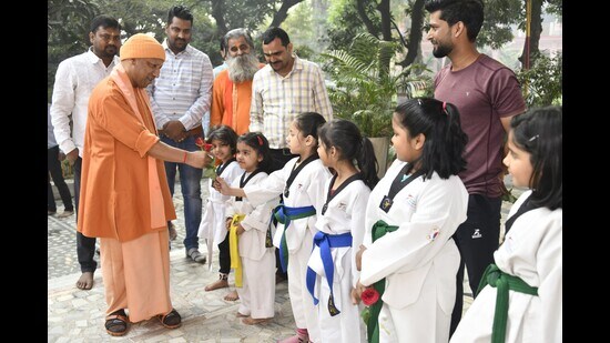 The Uttar Pradesh CM with children taking taekwondo training at Gorakhnath temple in Gorakhpur on Nov 14. (HT photo)