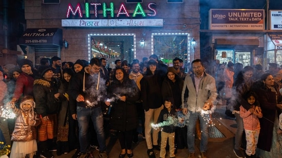 JERSEY CITY, NEW JERSEY - NOVEMBER 12: People hold sparklers as they celebrate Diwali on November 12, 2023 in Jersey City, New Jersey. Diwali (Getty Images via AFP)