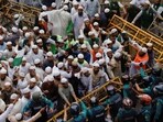 Members of the Islami Andolan Bangladesh, a political party, try to remove barricades as they join in a mass protest march towards the Election Commission, ahead of the election schedule declaration, in Dhaka.