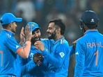 Virat Kohli (2R) celebrates with Shubman Gill (L), captain Rohit Sharma (2L) and KL Rahul after taking the wicket of Netherlands' captain Scott Edwards Virat Kohli (2R) celebrates with Shubman Gill (L), captain Rohit Sharma (2L) and KL Rahul after taking the wicket of Netherlands' captain Scott Edwards