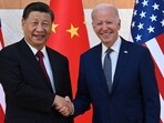 US President Joe Biden (R) and China's President Xi Jinping (L) shake hands.