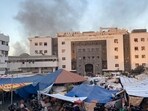 Smoke rises as displaced Palestinians take shelter at Al Shifa hospital, amid the ongoing conflict between Hamas and Israel. (Reuters)