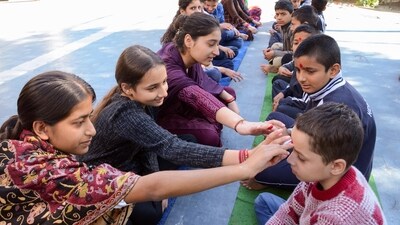 Sisters apply tilak to their brothers' foreheads on the occasion of the Bhai Dooj at Ved Mandir Bal Niketan in Jammu. (ANI) Sisters apply tilak to their brothers' foreheads on the occasion of the Bhai Dooj at Ved Mandir Bal Niketan in Jammu. (ANI)