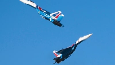 Members of the Russian air force's Russian Knights precision flying squad pass so close to each other that the jet wash can be seen over one of the aircraft at the Dubai Air Show in Dubai, United Arab Emirates, Monday. (AP) Members of the Russian air force's Russian Knights precision flying squad pass so close to each other that the jet wash can be seen over one of the aircraft at the Dubai Air Show in Dubai, United Arab Emirates, Monday. (AP)