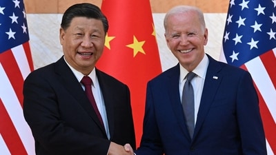 US President Joe Biden (R) and China's President Xi Jinping (L) shake hands. (AFP)