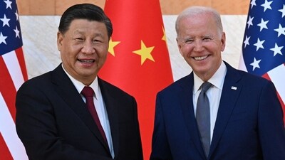 US President Joe Biden (R) and China's President Xi Jinping (L) shake hands. (AFP)