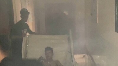 Al-Shifa Raid: Medics move a patient through the smoke-filled corridors inside Al Shifa hospital following an Israeli raid. (Reuters)