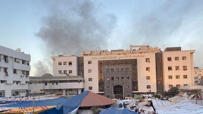 Smoke rises as displaced Palestinians take shelter at Al Shifa hospital, amid the ongoing conflict between Hamas and Israel. (Reuters)
