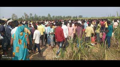 People gather at the spot where a man was mauled to death by a tiger, near Basukpur village of the Dudhwa buffer zone on Wednesday (Sourced)
