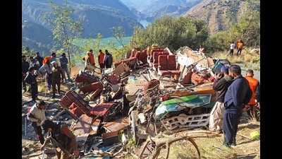 Security personnel and rescue workers gather beside the mangled remains of the bus in Doda on Wednesday. (AFP) Security personnel and rescue workers gather beside the mangled remains of the bus in Doda on Wednesday. (AFP)