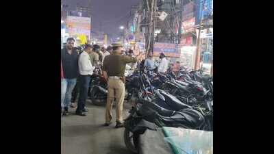 Traffic cops warning bike owners against parking vehicles erratically in Prayagraj (HT Photo)