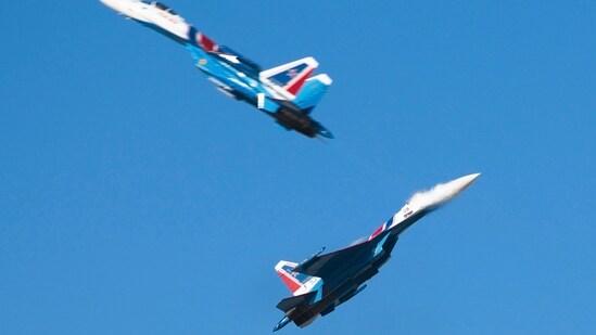 Members of the Russian air force's Russian Knights precision flying squad pass so close to each other that the jet wash can be seen over one of the aircraft at the Dubai Air Show in Dubai, United Arab Emirates, Monday.(AP)