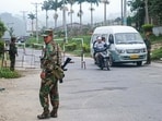This photo taken on November 10, 2023 shows fighters of the ethnic rebel group Ta'ang National Liberation Army (TNLA) standing guard at a check point in the town of Namhkam in northern Shan state.