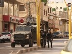 Israeli security forces surround the area of a Palestinian home, believed to belong to one of the gunmen that attacked an Israel checkpoint.