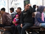 A Palestinian man holds a child as he and others ride on a horse drawn cart along a wet street following overnight rainstorms in Rafah in the southern Gaza Strip A Palestinian man holds a child as he and others ride on a horse drawn cart along a wet street following overnight rainstorms in Rafah in the southern Gaza Strip