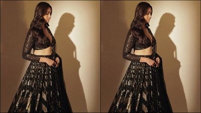 Her outfit featured a deep v-neck blouse with full sleeves and intricate sequin embroidery all over, paired with a matching flared skirt with gold and black embroidered sequin detailing throughout. She completed her look with a matching net duppata. (Instagram/@mrunalthakur) Her outfit featured a deep v-neck blouse with full sleeves and intricate sequin embroidery all over, paired with a matching flared skirt with gold and black embroidered sequin detailing throughout. She completed her look with a matching net duppata. (Instagram/@mrunalthakur)