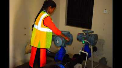 A woman pump operator busy in her work at a village in Prayagraj. (HT) A woman pump operator busy in her work at a village in Prayagraj. (HT)