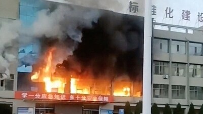 Fire burns at the Yongju Coal Industry Joint Building, in Luliang City, Shanxi province, China. (Reuters)