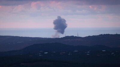 A picture taken from northern Israel on the border with Lebanon shows smoke billowing after an Israeli strike on the southern Lebanese area (AFP)