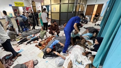 Palestinians wounded in Israeli strikes lie on the floor as they are assisted at the Indonesian hospital after Al Shifa hospital has gone out of service amid Israeli ground offensive. (REUTERS)