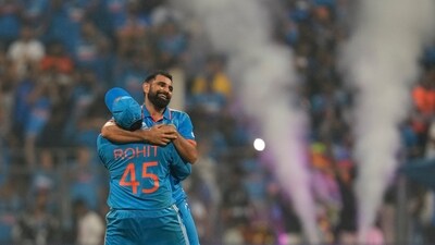 India's captain Rohit Sharma lifts Mohammed Shami after he took the last wicket and overall seven wickets to beat New Zealand by 70 runs during the ICC Men's Cricket World Cup first semifinal match in Mumbai (AP) India's captain Rohit Sharma lifts Mohammed Shami after he took the last wicket and overall seven wickets to beat New Zealand by 70 runs during the ICC Men's Cricket World Cup first semifinal match in Mumbai (AP)