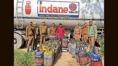 Police with the seized cylinders, LPG tankers and two accused in Samba on Thursday (HT Photo)