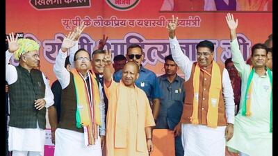 Uttar Pradesh chief minister Yogi Adityanath waves to the crowd during the public meeting ahead of Rajasthan Assembly elections, at Pushkar, in Ajmer on Thursday. (ANI Photo) Uttar Pradesh chief minister Yogi Adityanath waves to the crowd during the public meeting ahead of Rajasthan Assembly elections, at Pushkar, in Ajmer on Thursday. (ANI Photo)