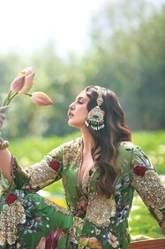 The actor poses in a green sharara set with gold sequins, beads and cutdana. The actor poses in a green sharara set with gold sequins, beads and cutdana.