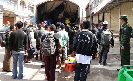 In this photo provided by The Kokang online media, members of the Myanmar National Democratic Alliance Army ethnic armed organization herd soldiers of the army battalion and their family members who surrendered to them two days earlier on to a truck, on Nov. 14, 2023 in Kokang Self-Administered Zone in Myanmar's northern Shan state. (AP) In this photo provided by The Kokang online media, members of the Myanmar National Democratic Alliance Army ethnic armed organization herd soldiers of the army battalion and their family members who surrendered to them two days earlier on to a truck, on Nov. 14, 2023 in Kokang Self-Administered Zone in Myanmar's northern Shan state. (AP)
