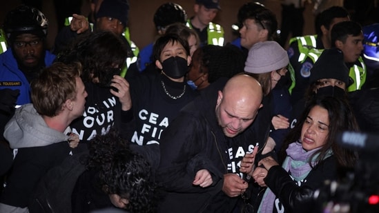 WASHINGTON, DC - NOVEMBER 15: Members of U.S. Capitol Police push protesters away from the headquarters of the Democratic National Committee during a demonstration against the war between Israel and Hamas on November 15, 2023 on Capitol Hill in Washington, DC. (Getty Images via AFP)