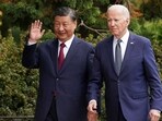 Chinese President Xi Jinping waves as he walks with US President Joe Biden at Filoli estate on the sidelines of the Asia-Pacific Economic Cooperation (APEC) summit, in Woodside, California.