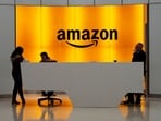 FILE - In this Feb. 14, 2019, file photo people stand in the lobby for Amazon offices in New York. Amazon is kicking off its annual security-focused cloud computing conference on Tuesday amid a slowdown in its profitable cloud business Amazon Web Services, or AWS. (AP Photo/Mark Lennihan, File) FILE - In this Feb. 14, 2019, file photo people stand in the lobby for Amazon offices in New York. Amazon is kicking off its annual security-focused cloud computing conference on Tuesday amid a slowdown in its profitable cloud business Amazon Web Services, or AWS. (AP Photo/Mark Lennihan, File)