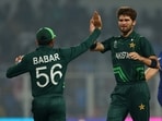 Pakistan's Shaheen Afridi celebrates with Babar Azam after taking the wicket of England's Joe Root 