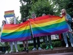 LGBT activists wave their flags during a rally to cancel the results of voting on amendments to the Constitution in Moscow
