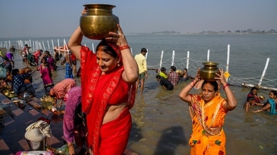 Worshipers conduct rituals during the Nahay Khay of the Chhath Puja festival in Patna on Friday, carrying sacred water from the Ganga river. (ANI Photo) Worshipers conduct rituals during the Nahay Khay of the Chhath Puja festival in Patna on Friday, carrying sacred water from the Ganga river. (ANI Photo)
