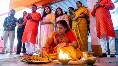 In Patna on Friday, a devotee partakes of prasad, the blessed offering, as part of the 'Nahay Khay' ritual during the Chhath Puja festival. (ANI Photo) In Patna on Friday, a devotee partakes of prasad, the blessed offering, as part of the 'Nahay Khay' ritual during the Chhath Puja festival. (ANI Photo)