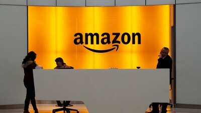 FILE - In this Feb. 14, 2019, file photo people stand in the lobby for Amazon offices in New York. Amazon is kicking off its annual security-focused cloud computing conference on Tuesday amid a slowdown in its profitable cloud business Amazon Web Services, or AWS. (AP Photo/Mark Lennihan, File) (AP)