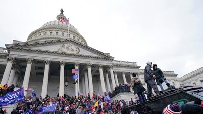 Rioters loyal to Donald Trump stand on vehicles and the steps of the U.S. Capitol on Jan. 6, 2021, in Washington. (AP) Rioters loyal to Donald Trump stand on vehicles and the steps of the U.S. Capitol on Jan. 6, 2021, in Washington. (AP)