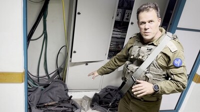 An Israeli officer points at what he describes as weapons discovered at the Al Shifa hospital complex, amid the Israeli military's ground operation against Palestinian Islamist group Hamas, (REUTERS)