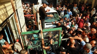 Palestinians queue as they wait to buy bread from a bakery, amid shortages of food supplies and fuel, as the conflict between Israel and Palestinian Islamist group Hamas continues in Khan Younis in the southern Gaza  on November 17. (Reuters)