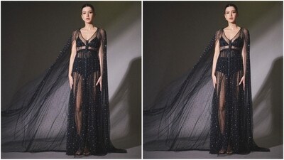 Her outfit features a v-neck, black bralette, high-waisted shorts and a sheer black floor-length gown embellished with white shimmer detailing all over, adding extra glamour to her look. (Instagram/@shanayakapoor02) Her outfit features a v-neck, black bralette, high-waisted shorts and a sheer black floor-length gown embellished with white shimmer detailing all over, adding extra glamour to her look. (Instagram/@shanayakapoor02)