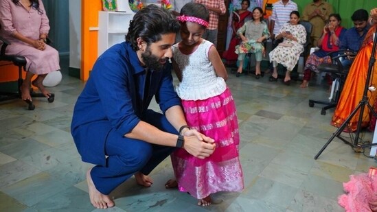 Naga Chaitanya with a child in Hyderabad.