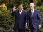 Chinese President Xi Jinping waves as he walks with US President Joe Biden at Filoli estate on the sidelines of the Asia-Pacific Economic Cooperation (APEC) summit, in Woodside, California.