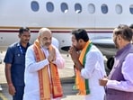 Union Home Minister Amit Shah being received by Union Minister and Telangana BJP President G. Kishan Reddy upon his arrival at Shamshabad airport, near Hyderabad on November 18.