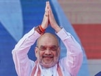 Union Home Minister Amit Shah with BJP leaders waves to the crowd during a public meeting in Jogulamba Gadwal district on November 18.